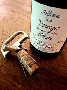 a bottle of wine with a wine cork next to it at DOMAINE DE LABROUSSE, Maison d'hôtes en Périgord in Agonac