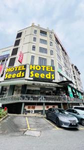 a hotel with a car parked in a parking lot at Seeds Hotel Cheras Taman Bukit Segar in Cheras