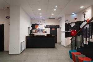 an office with a reception desk and colorful chairs at Equity Point Budapest in Budapest