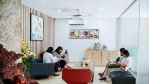 a group of people sitting in a room at New Sun Hotel Phu Nhuan in Ho Chi Minh City