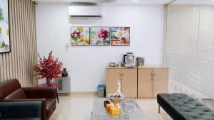 a living room with a couch and a table at New Sun Hotel Phu Nhuan in Ho Chi Minh City