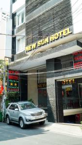 a car parked in front of a new sun hotel at New Sun Hotel Phu Nhuan in Ho Chi Minh City