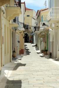 an empty street in a town with buildings at Sweet & Cosy Αpartment in Chora's old town in Andros