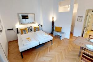 a living room with a white couch and a table at Homelystay Graz - downtown app in Graz