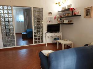 a living room with a blue couch and a television at La Piccola Oasi con parcheggio in Florence