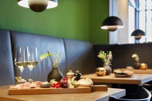 a table with food and wine glasses on it at Wedina Serviced Apartments in Hamburg