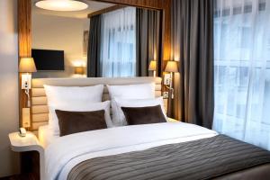 Postel nebo postele na pokoji v ubytování Leonardo Boutique Hotel Krakow City Center