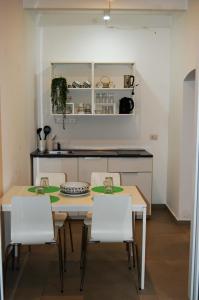 a kitchen with a table and chairs in a room at Amalò Guest House in Bari