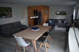 a dining room and living room with a table and chairs at Ferienwohnung JaRa 1 in Stolberg