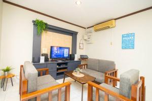 a living room with a couch and a tv at Loft Villa 1190 - Islamic Homestay in Malacca