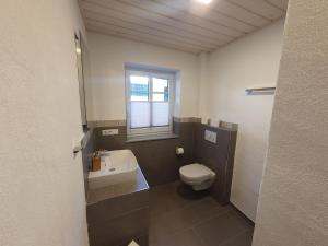 a small bathroom with a toilet and a sink at Bleibe in der Brandgasse in Alken