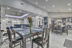 a dining room and kitchen with a table and chairs at Patio and Grill Spacious Gem Near Gulf Coast! in Brownsville