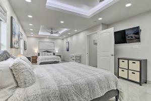 a bedroom with two beds and a television in it at Patio and Grill Spacious Gem Near Gulf Coast! in Brownsville