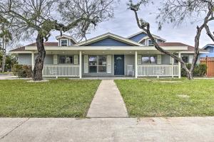 a house with a white fence and a tree at Spacious Texas Vacation Home Near Gulf Coast in Brownsville