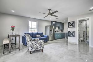 a living room with a blue couch and a kitchen at Patio and Balcony Gulf Coast Retreat in Brownsville in Brownsville
