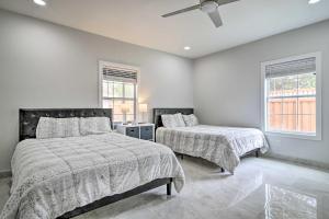 a bedroom with two beds and a ceiling fan at Patio and Balcony Gulf Coast Retreat in Brownsville in Brownsville