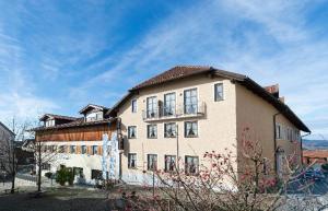 a large building with a balcony on top of it at Landhotel Zum Jägerstöckl in Grafenau