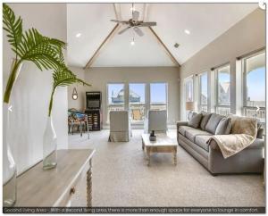 a living room with a couch and a table at SEAFOAM - Beautiful Luxury Beachside Village Home - Breathtaking Ocean Views- Full Reno in Galveston