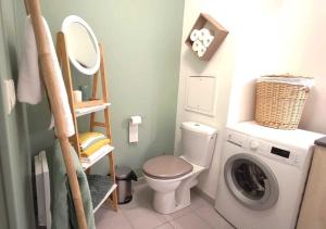 a bathroom with a toilet and a washing machine at Appart Poissy Relax Wi-Fi Pool by Servallgroup in Carrières-sous-Poissy