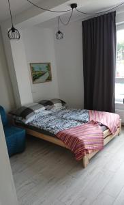 a bedroom with a bed in a room with a window at Sercówka Międzyzdroje in Międzyzdroje