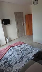a bedroom with a bed with a blanket on the floor at Sercówka Międzyzdroje in Międzyzdroje