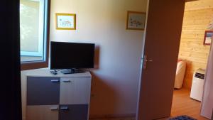 a room with a television on top of a cabinet at CHALETS Climatisés in Salernes
