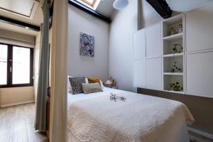 a bedroom with a bed with white cabinets and a window at Cityhome Apartments in the heart of Antwerp in Antwerp