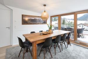 a dining room with a wooden table and chairs at Chalet am Breitenberg Appartement CB 12 in Pfronten