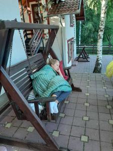 a little girl is sleeping on a swing at Gočke Lux vile & Duplex in Vrnjačka Banja
