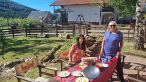a man and woman sitting at a table with food at Gočke Lux vile & Duplex in Vrnjačka Banja