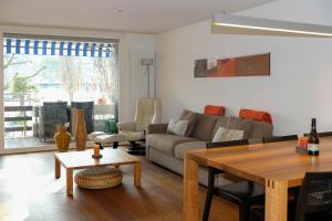 a living room with a couch and a table at Buchtoase in Spiez