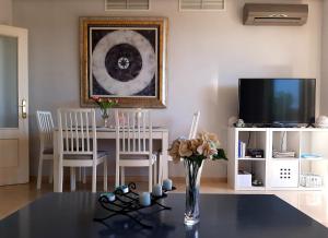 a living room with a table and a tv at Judith Apartment-Lovely duplex in Benalmadena in Benalmádena