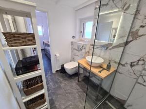 a bathroom with a shower and a sink and a toilet at Gythio townhouse in Gythio +90 photos