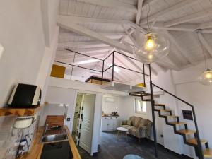 a room with a staircase and a living room at Gythio townhouse in Gythio