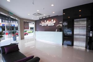 a lobby of a store with a couch and a counter at Hotel Mezzo in Kuala Lumpur