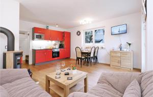 a living room with a couch and a table at Reetdachhaus Moin-moin in Kutzow