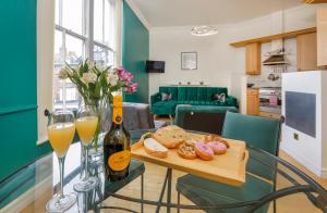 a table with glasses of wine and a tray of bread at York Suite on the historic Shambles, sleeps 6 in York