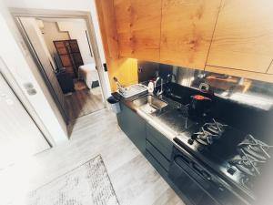 a kitchen with a sink and a stove top oven at The Beehive in Mytilini