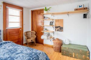 a bedroom with a bed and a wooden floor at Bohemian Compound with Hot Tub in Winooski