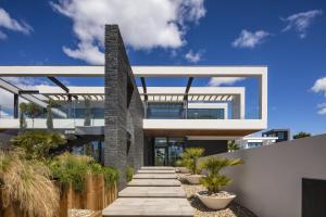 a modern house with a pathway in front of it at Vale do Lobo Sky Villa by Homing in Vale do Lobo