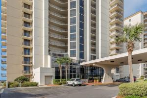 a parking lot in front of a large apartment building at Phoenix VIII by Brett Robins Vacations in Orange Beach