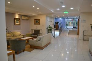 eine Lobby mit Sofas, Stühlen und einem Tisch in der Unterkunft Hotel Centro Naval in Buenos Aires