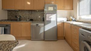 a kitchen with a refrigerator and a dishwasher at Place in the sun - Free out door Jacuzzi - BY BEDZY in Albufeira
