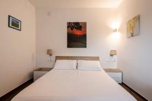 a bedroom with a large white bed with two night stands at Soul Apartment in Rome, Vatican Museum in Rome +41 photos