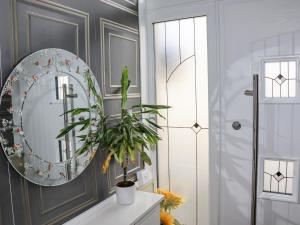 a bathroom with a mirror and a plant on a counter at 112 Balmoral Road in Morecambe