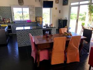 a kitchen with a wooden table with orange chairs at Bel ombre's Panoramic view in Bel Ombre