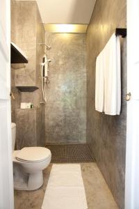 a bathroom with a toilet and a shower at 99 Oldtown Boutique Guesthouse SHA EXTRA PLUS in Phuket Town