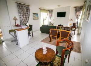 a living room with a table and chairs at Luxury Chez-Moi in Serres