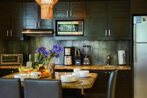 a kitchen with a table with fruit on it at El Taj Oceanfront and Beachside Condo Hotel in Playa del Carmen