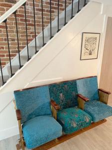 two chairs sitting under a stair case at Chapel Theatre House in Sandgate